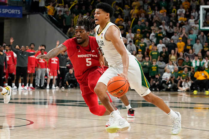 Feb 24, 2024; Waco, Texas, USA; Baylor Bears guard RayJ Dennis (10) works past Houston Cougars forward Ja'Vier Francis (5) during the second half at Paul and Alejandra Foster Pavilion. Mandatory Credit: Raymond Carlin III-USA TODAY Sports